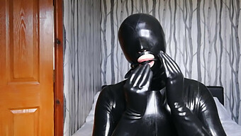 Latex-Clad Figure Restrained And Silenced